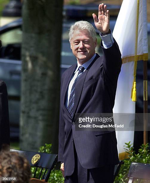 Former U.S. President Bill Clinton waves at the Milton Academy Commencement ceremonies June 6, 2003 in Milton, Massachusetts. Clinton delivered a...