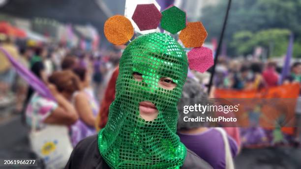 Women are participating in an event on International Women's Day on Avenida Paulista in Sao Paulo in the afternoon of Friday, March 8.