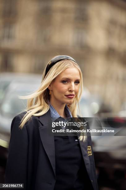 Leonie Hanne wears white mini skirt, blue shirt, navy bue vest and a hand bag outside Miu Miu during the Womenswear Fall/Winter 2024/2025 as part of...