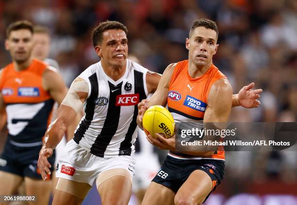 Josh Kelly of the Giants is tackled by Ash Johnson of the Magpies during the 2024 AFL Opening Round match between the GWS GIANTS and the Collingwood...