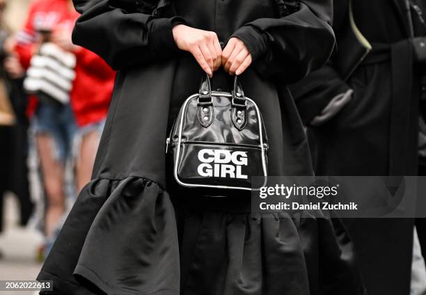 Coto is seen wearing a black Comme Des Garcons dress and CDG bag with white sneakers and white sheer headpiece outside the Miu Miu show during the...