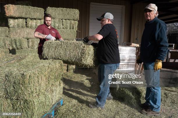 Todd Pinkston picks up some donated hay to help feed his cattle after the Smokehouse Creek fire burned through his ranch on March 05, 2024 in...
