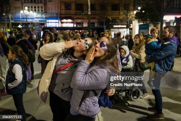 Two young people are making sounds with their throats during a feminist demonstration that is touring the streets of Santander, Spain, on March 8, to...