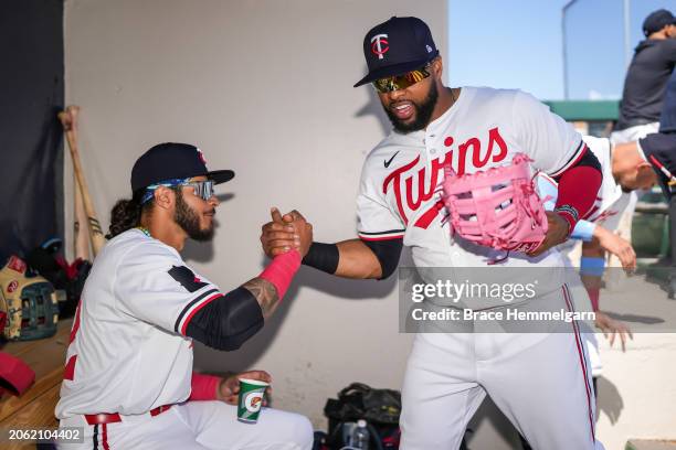 Austin Martin and Carlos Santana of the Minnesota Twins look on during a spring training game against the Pittsburgh Pirates on February 24, 2024 at...