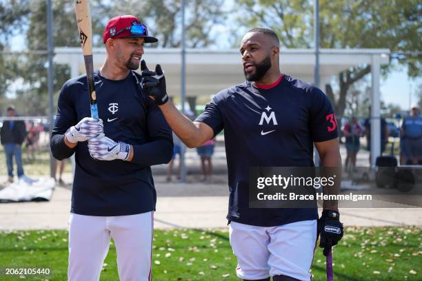 Royce Lewis talks with Carlos Santana of the Minnesota Twins during a workout prior to a spring training game against the Pittsburgh Pirates on...