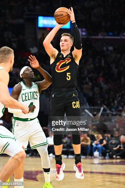 Sam Merrill of the Cleveland Cavaliers shoots the ball against Jrue Holiday of the Boston Celtics during the third quarter at Rocket Mortgage...