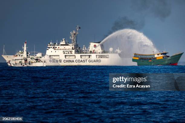 Chinese Coast Guard ship fires a water cannon at Unaizah May 4, a Philippine Navy chartered vessel, conducting a routine resupply mission to troops...