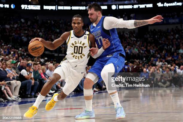 Bennedict Mathurin of the Indiana Pacers dribbles the ball to the basket against Luka Doncic of the Dallas Mavericks in the second half at American...