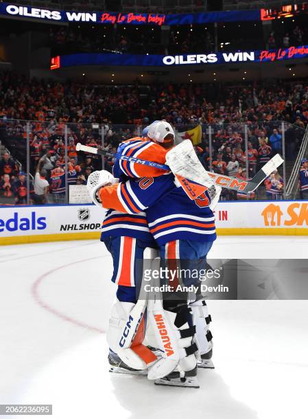 Calvin Pickard of the Edmonton Oilers celebrates a win by teammate Stuart Skinner who sets the franchise record for consecutive wins by a goalie...
