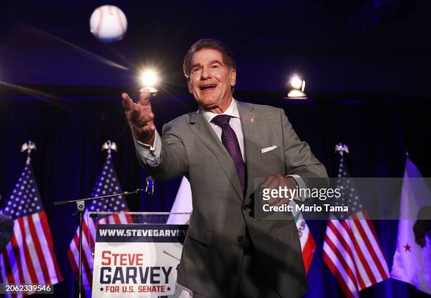 Republican Senate candidate Steve Garvey, a former Los Angeles Dodgers baseball player, tosses a baseball to supporters at his election night watch...