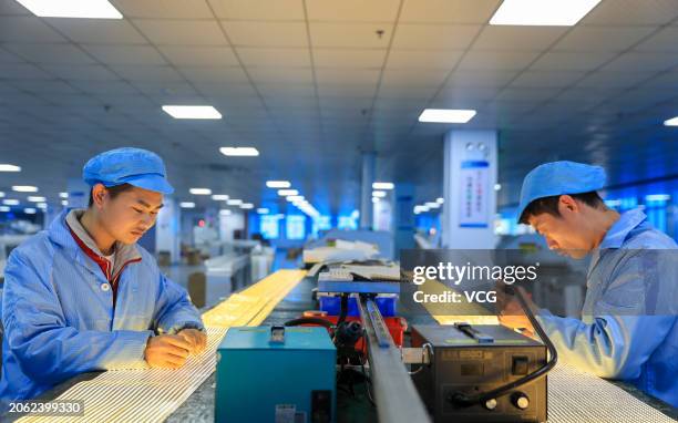 Employees work on the production line of LED strip lights at Jingyuxin Lighting Technology Co., Ltd. On March 6, 2024 in Jiujiang, Jiangxi Province...