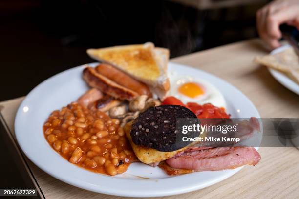 Full English breakfast on a plate in a 'greasy spoon' cafe on 3rd February 2024 in Birmingham, United Kingdom. Also known as a caf, these places...