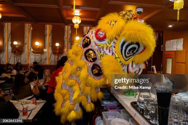 Lion Dance to celebrate the Chinese New Year of the Dragon enters a restaurant in Chinatown to bless them for the year ahead on 10th February 2024 in...