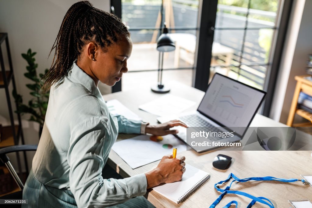 Diligent woman working at her desk in a small office