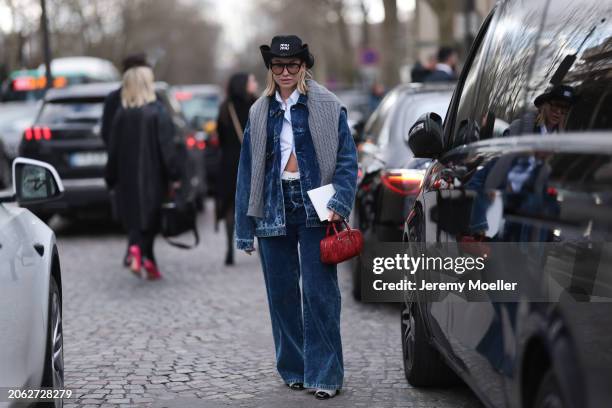 Karin Teigl seen wearing Miu Miu black denim logo cowboy hat, black aviator glasses, Miu Miu light blue striped buttoned shirt, Miu Miu grey cable...