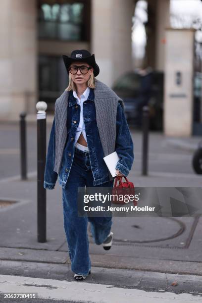 Karin Teigl seen wearing Miu Miu black denim logo cowboy hat, black aviator glasses, Miu Miu light blue striped buttoned shirt, Miu Miu grey cable...