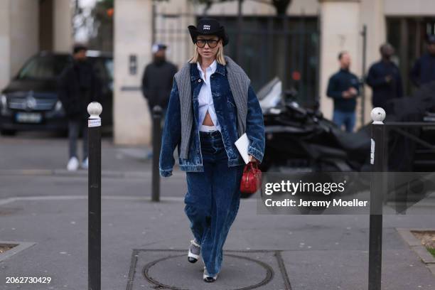 Karin Teigl seen wearing Miu Miu black denim logo cowboy hat, black aviator glasses, Miu Miu light blue striped buttoned shirt, Miu Miu grey cable...