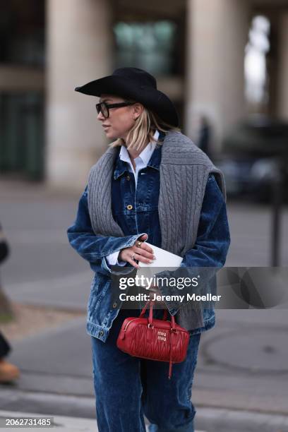 Karin Teigl seen wearing Miu Miu black denim logo cowboy hat, black aviator glasses, Miu Miu light blue striped buttoned shirt, Miu Miu grey cable...