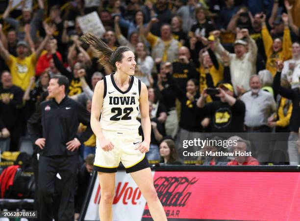 Guard Caitlin Clark of the Iowa Hawkeyes celebrates after breaking Pete Maravichs all-time NCAA scoring record during the first half against the Ohio...