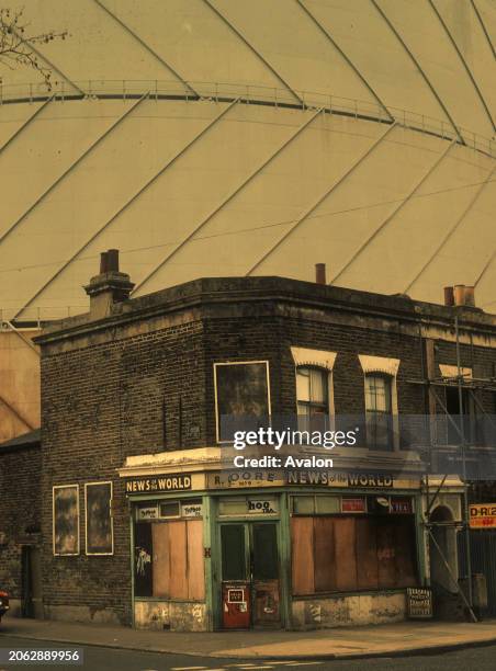 Old Victorian London Corner Shop With Gasworks Behind Ready For Demolition, London, UK, 1970.