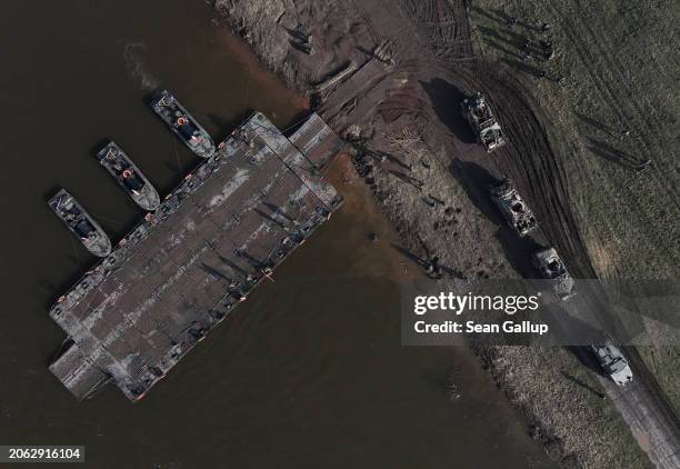 In this aerial view British troops in Mastiff and Jackal vehicles finish crossing the Vistula River on a Polish military ferry during the NATO Dragon...