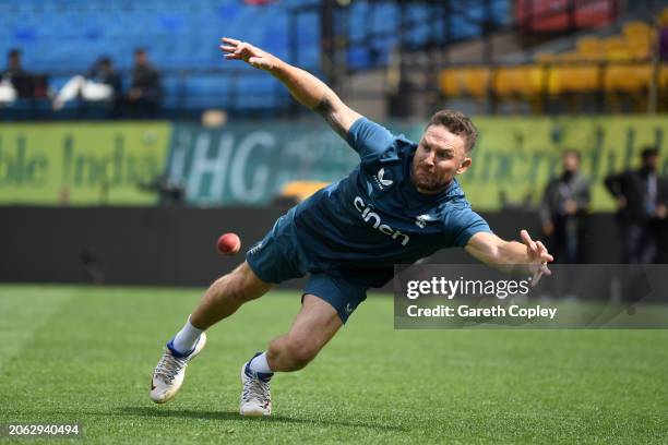 England coach Brendon McCullum dives for a ball during a nets session at Himachal Pradesh Cricket Association Stadium on March 06, 2024 in...