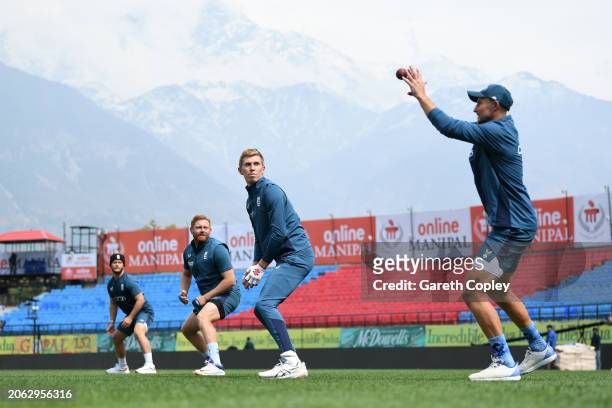 Joe Root of England catches in the slips alongside Ben Duckett, Jonathan Bairstow and Zak Crawley during a nets session at Himachal Pradesh Cricket...