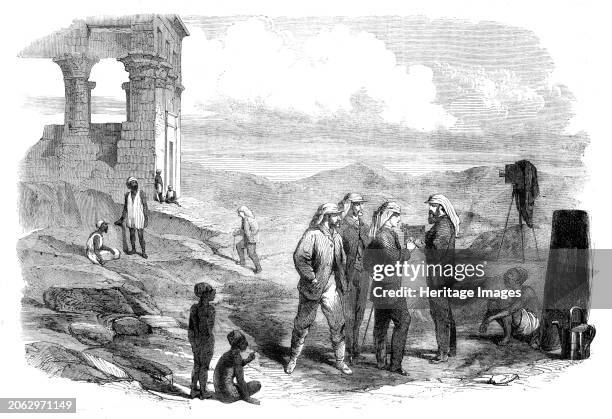 The Prince of Wales' Visit to Egypt: His Royal Highness examining the negatives taken by Mr. Bedford, photographist, at Philae, 1862. The future King...