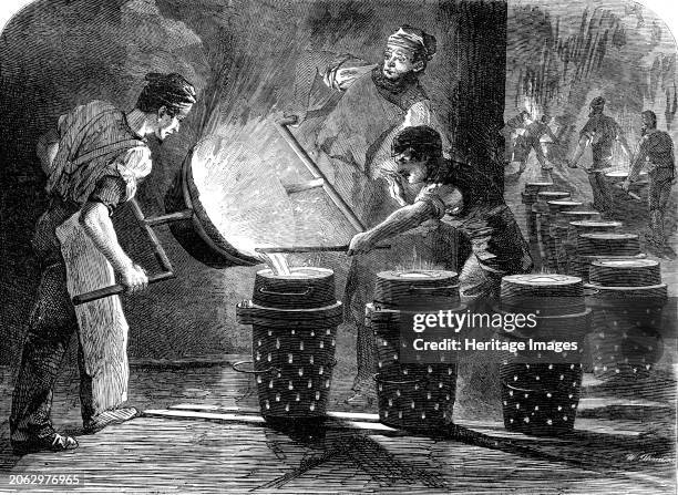 Manufacture of the Armstrong Gun at Woolwich Arsenal: casting the shot and shell for 100 pounders, 1862. 'In viewing the manner in which the work is...