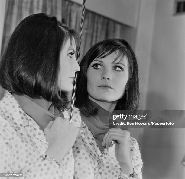 English singer Sandie Shaw posed with her face reflected in a mirror, London circa 1966.