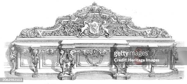 Drawing-room sideboard, by Morant, Boyd, and Morant, in the International Exhibition, 1862. 'The shelf is sustained by eight richly-carved legs...The...