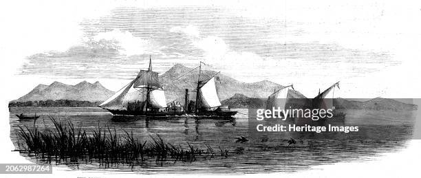 Visit of H.M.S. Gorgon to the Zambesi River: The Pioneer passing Mozambala with boats in tow laden with parts of the steamer for Dr. Livingstone,...