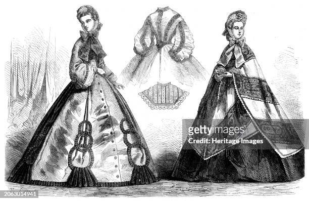 Paris fashions for November, 1862. 'Fig. 1. Visiting Dress. Robe of plain mauve silk, trimmed with six triple-ringed passementerie ornaments on the...