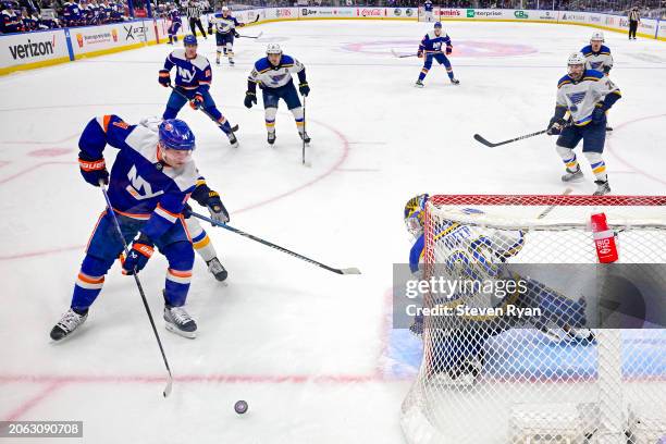 Joel Hofer of the St. Louis Blues tends net against Bo Horvat of the New York Islanders during the game at UBS Arena on March 05, 2024 in Elmont, New...