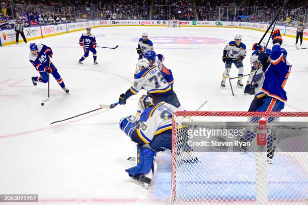 Noah Dobson of the New York Islanders attempts a shot against Joel Hofer of the St. Louis Blues during the game at UBS Arena on March 05, 2024 in...