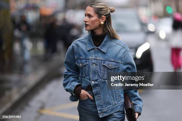 Helena Bordon is seen wearing a Hermes denim jeans jacket, denim pants, black turtleneck, blue boots and Hermes brown clutch outside Hermes show,...