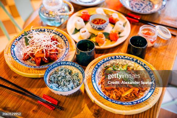 various food served for dinner at vietnamese restaurant - plate side view stock pictures, royalty-free photos & images