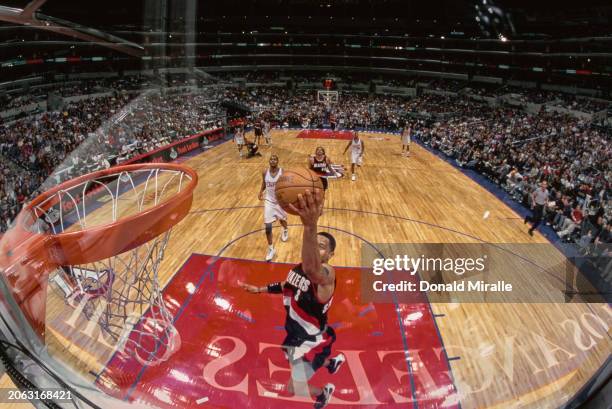 Damon Stoudamire, Point Guard for the Portland Trail Blazers makes a lay up shot to the basket during the NBA Pacific Division basketball game...