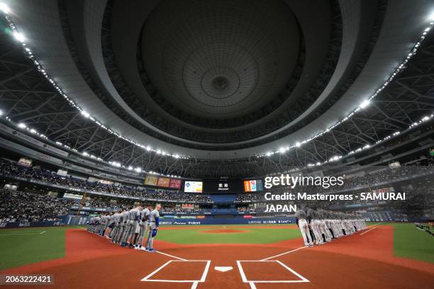 Players line up to observe a minute of silence for the victims of the Noto Peninsula earthquakes prior to the game between Samurai Japan and Team...