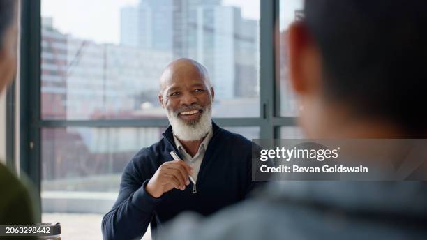 meeting, interview and mature business black man in boardroom of office for feedback or review. face, management and recruitment with happy employer in workplace for hiring or candidate opportunity - vacancy stock pictures, royalty-free photos & images