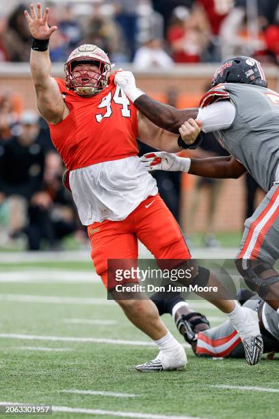 Defensive Lineman Braden Fiske of Florida State from the National Team is being blocked by Offensive Lineman Delmar Glaze of Maryland from the...