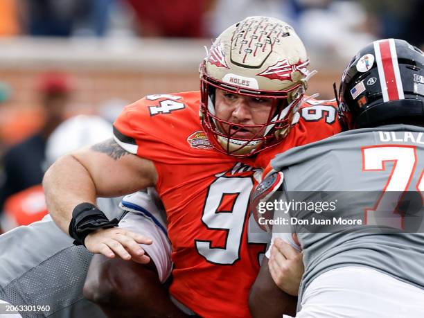 Defensive Lineman Braden Fiske of Florida State from the National Team is being blocked by Offensive Lineman Delmar Glaze of Maryland from the...