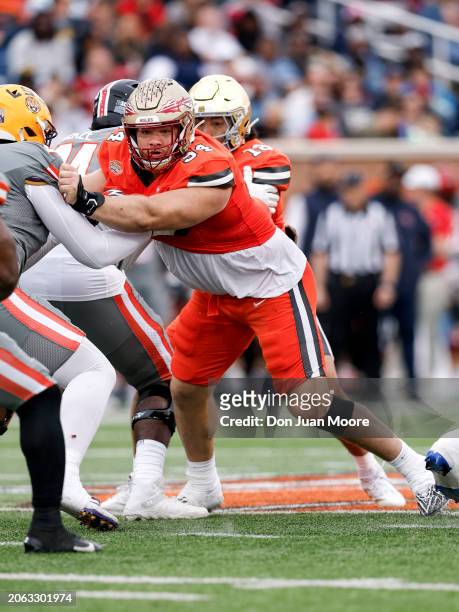 Defensive Lineman Braden Fiske of Florida State from the National Team is being defended by Offensive Lineman Charles Turner III of LSU from the...