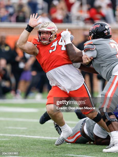 Defensive Lineman Braden Fiske of Florida State from the National Team is being blocked by Offensive Lineman Delmar Glaze of Maryland from the...