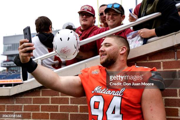 Defensive Lineman Braden Fiske of Florida State from the National Team pose to take a photo with fans after the 2024 Reese's Senior Bowl at Hancock...