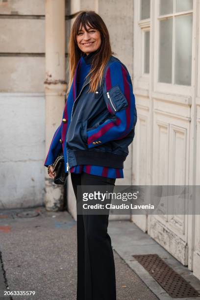 Caroline de Maigret wears burgundy and blue jacket, black pants, black bag, outside Sacai, during the Womenswear Fall/Winter 2024/2025 as part of...