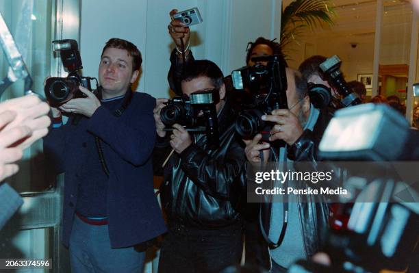 Photographers record celebrity arrivals during the opening party for a Tommy Hilfiger store on New Bond Street in London, England, circa late...