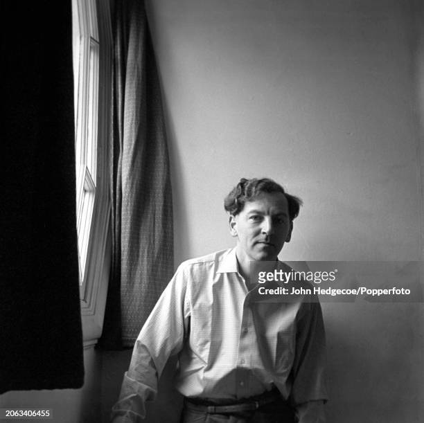 English novelist, journalist and writer Keith Waterhouse posed in a bedroom inside his house in London in 1959.