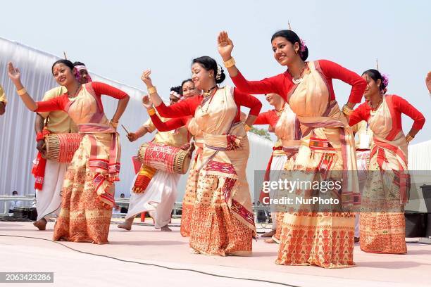 Assamese girls are performing a traditional Bihu dance during a program where Prime Minister Narendra Modi is speaking in Jorhat district, Assam,...