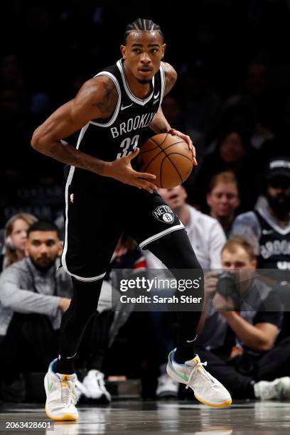 Nic Claxton of the Brooklyn Nets dribbles during the game against the Atlanta Hawks at Barclays Center on March 02, 2024 in the Brooklyn borough of...